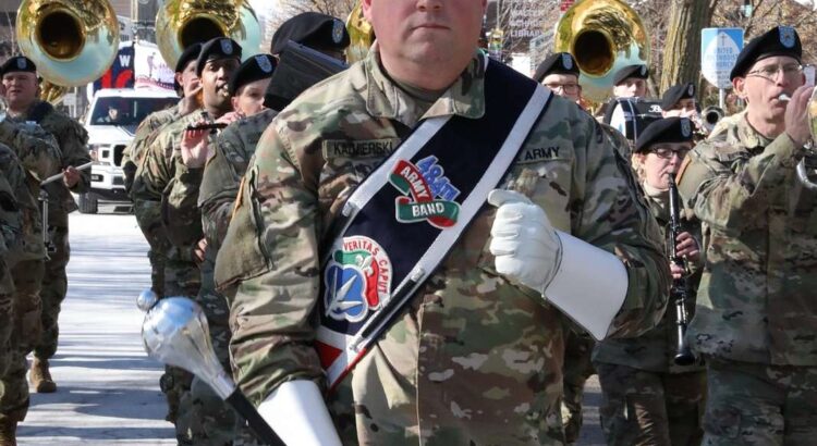 Staff Sergeant Jeff Kazmierski, 484th Army Band, leads a former Vets Day Parade; image for a Veterans Day 2022 blog post